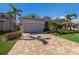 Charming house showcasing a spacious driveway, attached garage, and professionally landscaped front yard at 3605 Wild Blossom Pl, Parrish, FL 34219