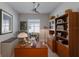 Bright home office featuring wood desk, shelving and floors, and a stylish ceiling fan for added comfort at 3605 Wild Blossom Pl, Parrish, FL 34219