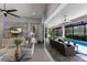 Open living room featuring a seamless transition to the screened-in lanai and pool area at 3605 Wild Blossom Pl, Parrish, FL 34219