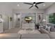 The living room boasts an accent wall and media center, complemented by comfortable seating and backyard view at 3605 Wild Blossom Pl, Parrish, FL 34219