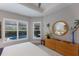 Bright main bedroom with a round mirror and palm tree decoration at 3605 Wild Blossom Pl, Parrish, FL 34219