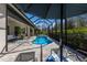 Inviting screened-in pool area featuring a sparkling pool, lounge chairs, and beautiful landscaping at 3605 Wild Blossom Pl, Parrish, FL 34219