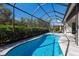 Inviting pool area with a screened-in lanai, providing privacy and shade for a refreshing outdoor experience at 3605 Wild Blossom Pl, Parrish, FL 34219