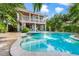 Charming backyard with a pool, spa, and spiral staircase, creating a tropical oasis perfect for outdoor living at 418 Magnolia Ave, Anna Maria, FL 34216