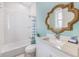 Comfortable bathroom with rope mirror, light blue wall paint and shower/bath combination at 418 Magnolia Ave, Anna Maria, FL 34216
