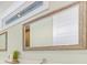 Modern bathroom showcasing a framed mirror and sleek fixtures on a bright white wall at 418 Magnolia Ave, Anna Maria, FL 34216