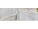 Bright bathroom featuring a glass enclosed shower, toilet, and white vanity with a light countertop at 418 Magnolia Ave, Anna Maria, FL 34216