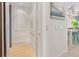 Hallway featuring elevator, light-colored wood floors, and an adjacent dining area at 418 Magnolia Ave, Anna Maria, FL 34216