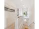 Hallway view with light tile floors, white walls, and an entryway with a screened door at 418 Magnolia Ave, Anna Maria, FL 34216