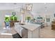 Bright, open kitchen with an island, seamlessly connected to the dining and living areas, filled with natural light at 418 Magnolia Ave, Anna Maria, FL 34216