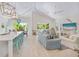 Bright, open living space with vaulted ceilings, coastal decor, light wood floors, and abundant natural light at 418 Magnolia Ave, Anna Maria, FL 34216
