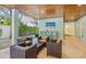 Inviting covered outdoor area featuring comfortable seating, a bar, and a television for relaxed entertaining at 418 Magnolia Ave, Anna Maria, FL 34216