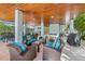 Inviting covered patio features comfortable seating, a billiards table, and an outdoor bar area at 418 Magnolia Ave, Anna Maria, FL 34216