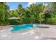 Beautifully landscaped pool and spa area surrounded by tropical greenery, creating a private backyard oasis at 418 Magnolia Ave, Anna Maria, FL 34216