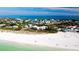 Coastal condo building on sandy beach with turquoise waters and beautiful surrounding community at 4200 Gulf Dr # 101, Holmes Beach, FL 34217