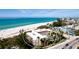 Beautiful aerial view of a condo building with a sandy beach and ocean in the background at 4200 Gulf Dr # 101, Holmes Beach, FL 34217