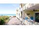 Balcony with chairs overlooking the beach and ocean at 4200 Gulf Dr # 101, Holmes Beach, FL 34217