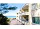 Balcony view with chairs overlooking the beach and ocean at 4200 Gulf Dr # 101, Holmes Beach, FL 34217
