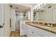 Bathroom showcasing granite countertops, dual sinks, and glass door shower at 4200 Gulf Dr # 101, Holmes Beach, FL 34217