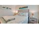 Bedroom with coastal decor, lamps, and beach themed artwork at 4200 Gulf Dr # 101, Holmes Beach, FL 34217