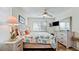 Bright bedroom features coastal decor, ceiling fan, and mounted television at 4200 Gulf Dr # 101, Holmes Beach, FL 34217