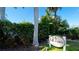 Gulf Sands 4200 community sign nestled amongst lush tropical foliage under a sunny sky at 4200 Gulf Dr # 101, Holmes Beach, FL 34217