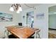 Charming dining area with beach-themed artwork and chandelier lighting at 4200 Gulf Dr # 101, Holmes Beach, FL 34217
