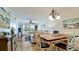 View from the dining area shows open living room and access to balcony at 4200 Gulf Dr # 101, Holmes Beach, FL 34217