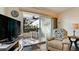 Cozy living room looks out to the relaxing outdoor seating on the covered balcony at 4200 Gulf Dr # 101, Holmes Beach, FL 34217