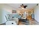 Comfortable living room has coastal decor, recliner, and is open to the dining area at 4200 Gulf Dr # 101, Holmes Beach, FL 34217