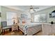 Bright main bedroom with a king bed, side tables, and lamps at 4200 Gulf Dr # 101, Holmes Beach, FL 34217