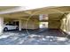 Covered parking area featuring parking spaces and storage units at 4200 Gulf Dr # 101, Holmes Beach, FL 34217