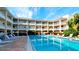 Outdoor pool features clear blue water and surrounding lounge area for relaxation at 4200 Gulf Dr # 101, Holmes Beach, FL 34217