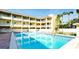 Community pool featuring clear blue water and lounge chairs for residents at 4200 Gulf Dr # 101, Holmes Beach, FL 34217