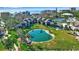 Aerial view of property showcasing pond, lush landscaping, and community amenities like tennis at 4234 Gulf Of Mexico Dr # H2, Longboat Key, FL 34228