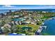 Aerial view of community showcasing manicured landscaping, pond, marina, swimming pool, and tennis courts at 4234 Gulf Of Mexico Dr # H2, Longboat Key, FL 34228