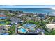 Beautiful aerial view of the beachfront property, featuring a pool, tennis court, and stunning ocean views at 4234 Gulf Of Mexico Dr # H2, Longboat Key, FL 34228