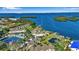 Stunning aerial view of the waterfront condos, showcasing a community pool, tennis court, and tranquil bay access at 4234 Gulf Of Mexico Dr # H2, Longboat Key, FL 34228