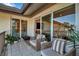Relax on this outdoor patio with a pair of cushioned chairs, a small table, and sliding doors to inside at 4234 Gulf Of Mexico Dr # H2, Longboat Key, FL 34228
