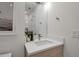 Modern bathroom features a sink with a stylish mirror and a vessel sink with a pot of orchids at 4234 Gulf Of Mexico Dr # H2, Longboat Key, FL 34228