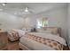 Bright bedroom featuring two beds, a ceiling fan, and a window overlooking the water for scenic views at 4234 Gulf Of Mexico Dr # H2, Longboat Key, FL 34228