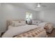 Bright bedroom featuring two beds, a ceiling fan, and a window for scenic views at 4234 Gulf Of Mexico Dr # H2, Longboat Key, FL 34228