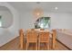 Cozy dining area featuring a wooden table, wicker chairs, and a modern chandelier at 4234 Gulf Of Mexico Dr # H2, Longboat Key, FL 34228