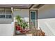 Inviting entrance featuring a well-lit doorway, potted plants, and textured stucco siding at 4234 Gulf Of Mexico Dr # H2, Longboat Key, FL 34228