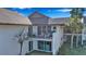 Exterior view of a home featuring a spacious balcony with patio furniture, and ground floor access at 4234 Gulf Of Mexico Dr # H2, Longboat Key, FL 34228