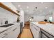 Contemporary kitchen with modern appliances, a center island, a long counter, and an open design at 4234 Gulf Of Mexico Dr # H2, Longboat Key, FL 34228