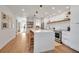 Bright kitchen with a waterfall island and seating, stainless steel appliances, and sleek design at 4234 Gulf Of Mexico Dr # H2, Longboat Key, FL 34228