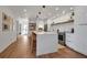 Bright, modern kitchen with quartz countertops, stainless steel appliances, and stylish wicker bar stools at 4234 Gulf Of Mexico Dr # H2, Longboat Key, FL 34228