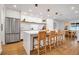 Well-lit kitchen with a large island, modern fixtures, open shelving, and stainless steel appliances at 4234 Gulf Of Mexico Dr # H2, Longboat Key, FL 34228
