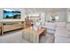 Bright living room featuring a large sectional sofa, modern decor, and an open layout into the kitchen at 4234 Gulf Of Mexico Dr # H2, Longboat Key, FL 34228